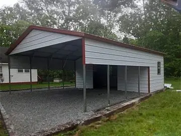 A carport with a metal roof and two sides.