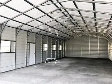 A large metal building with a ceiling and floor.