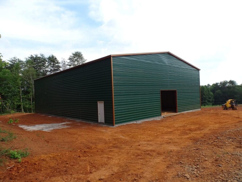 A green warehouse shed with a white color door