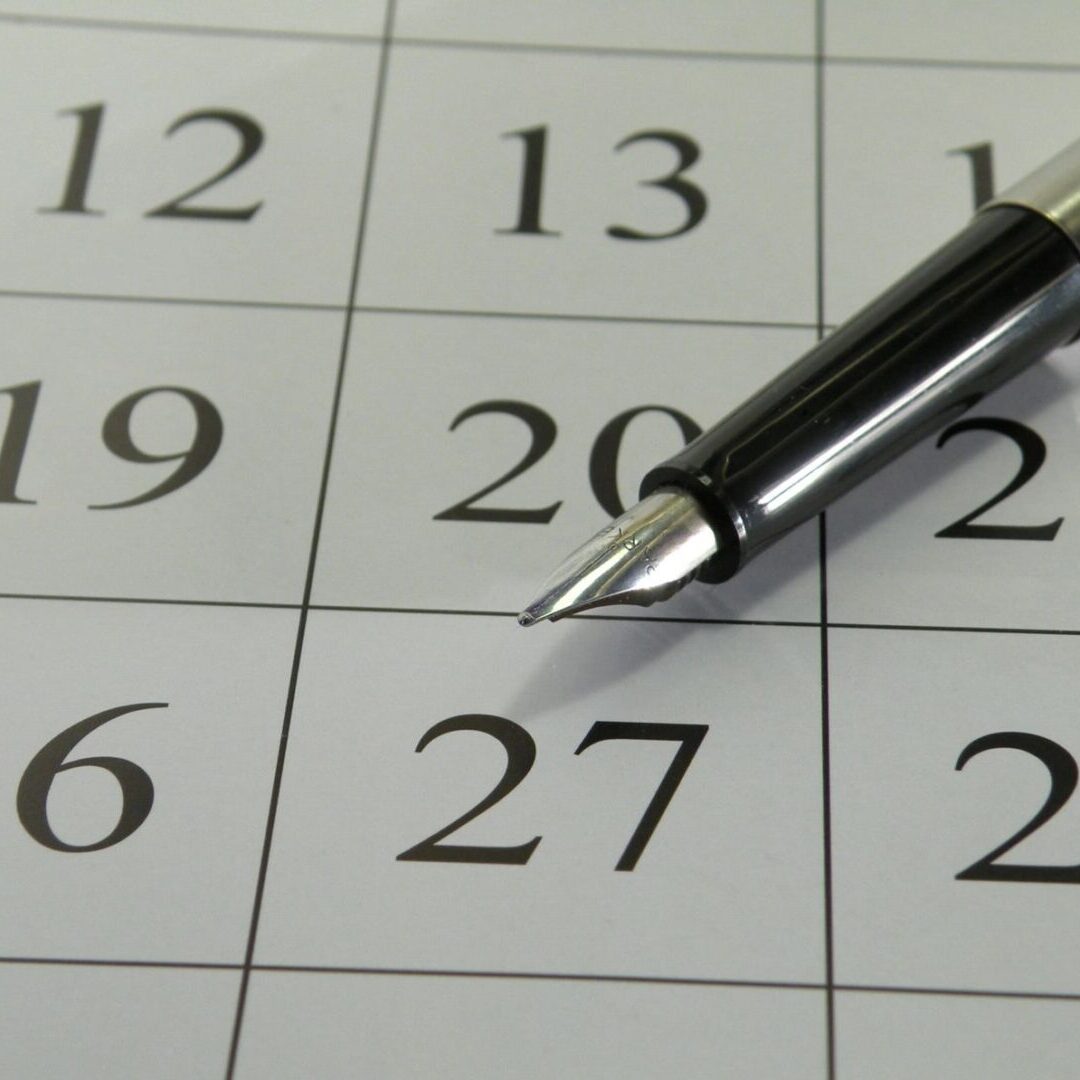 A close up of a pen on the calendar